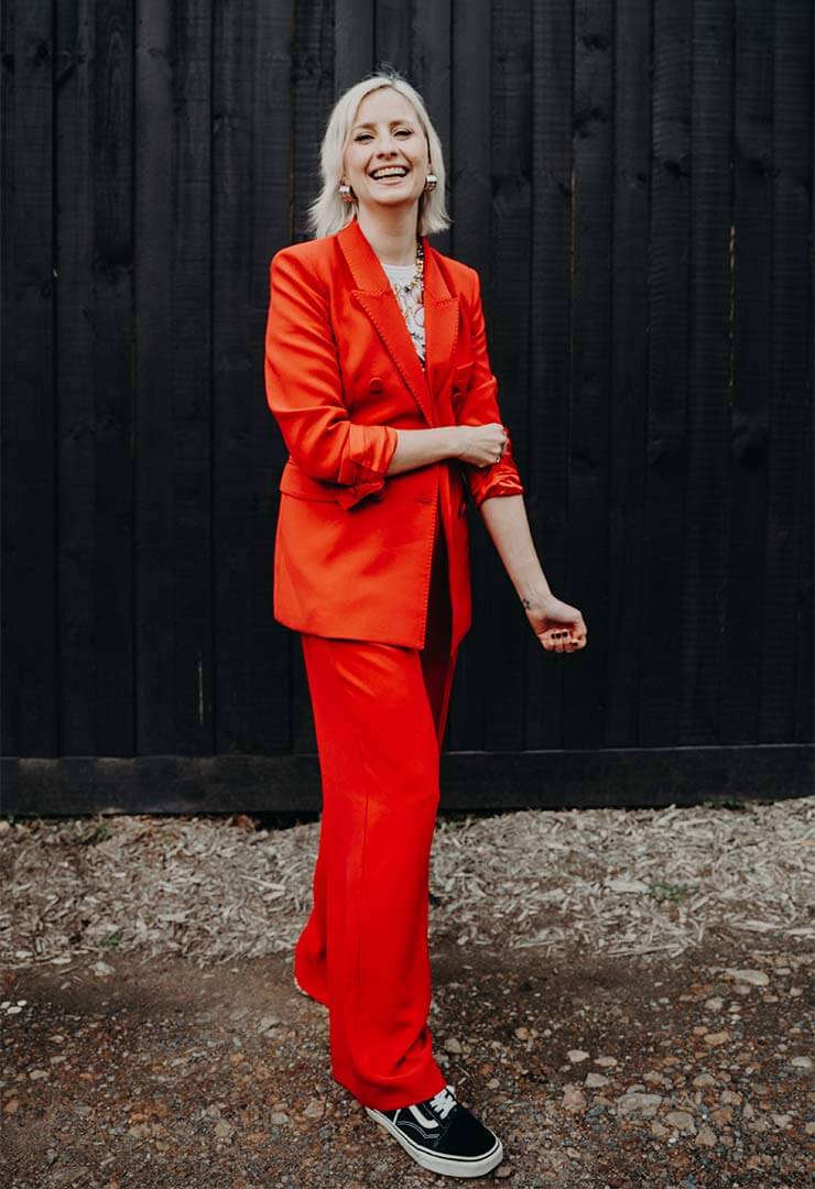 Cat Dunn, a melbourne online business manager wearing a red suit.