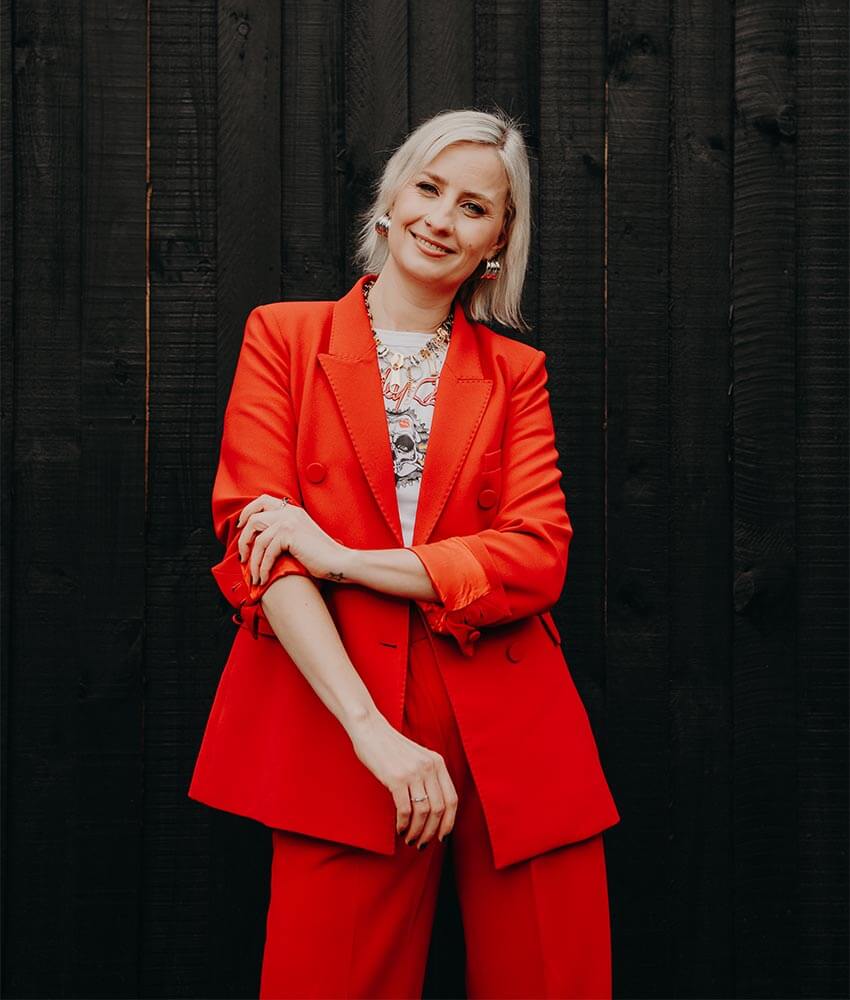 Cat Dunn, an online business manager, rolling up the sleeves of her red suit.