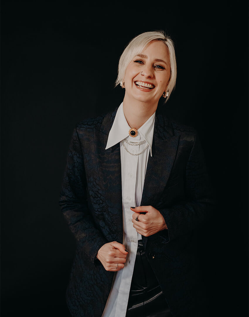 Business woman and panel speaker in a black suit.